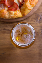 Beer and pizza. Glass of beer. Ale and appetizer snack. View from above, top