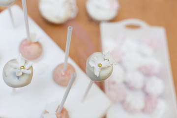 cakes in a vase on the buffet.