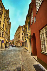 Naklejka na ściany i meble Old medieval morning narrow street in Riga, Latvia. Retro styled.