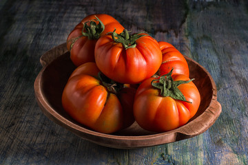 closeup of true organic tomato on rustic surface