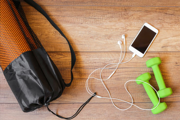 The concept of sport. Smartphone, yoga Mat, dumbbells, earphones, measuring tape, towel. A healthy lifestyle, sports to the music. Diet.