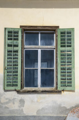 Window with old green shutters