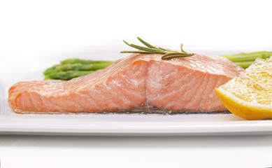 Steamed salmon and asparagus on a white plate