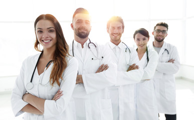 Portrait of medical team standing with arms crossed in hospital