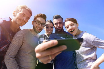 group of young people taking a selfie.