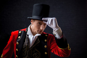 Showman. Young male entertainer, presenter or actor on stage. The guy in the red camisole and the...