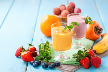 Orange persimmon blueberry smoothie   and fruits. Selective focus. Copy space. Top view