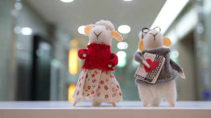 The sheep couple doll in front of the office entrance.