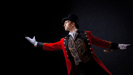 Showman. Young male entertainer, presenter or actor on stage. The guy in the red camisole and the...