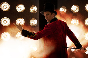 Showman. Young male entertainer, presenter or actor on stage. The guy in the red camisole and the...
