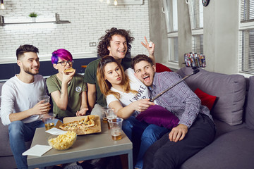 A group of friends are photographed on a camera indoors.