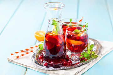 Summer drink Sangria with orange and cranberry. Selective focus. Copy space