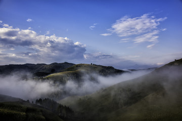 Beautiful mountain landscape of a foggy morning with trees and clouds, Dumesti, Salciua, Apuseni, Romania