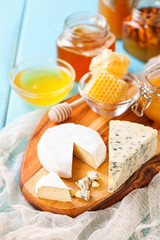 Cheese and honey on a table. Selective focus. Copy space