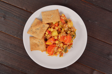 Baked vegetables and cheese biscuits on a table