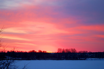 Naklejka premium Photo of a bright red dawn over the river