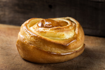 Close up of one Sweet spiral cake on wood