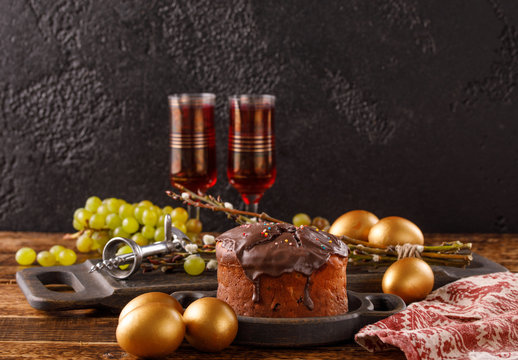 A Beautiful Easter Still Life With A Place Under Your Text. Delicious Home-made Easter Cake In Chocolate Glaze, Vintage Glasses With Red Wine And Traditional Painted Eggs.