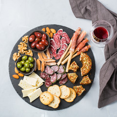 Assortment of spanish tapas or italian antipasti with wine