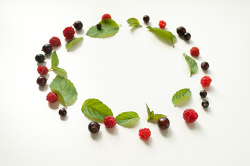 Composition with Fresh mint leaves and red raspberries and black