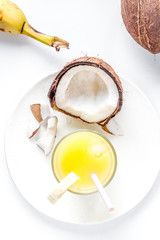 cocktail with coconut on white background top view