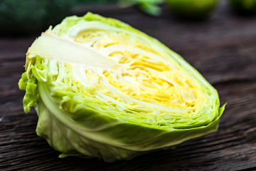 Obraz premium Half of fresh cabbage head on wooden surface