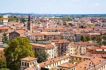 Fototapeta premium Panoramic cityscape of Verona, Veneto, Italy. Orange tiling medieval roofs. Bright sunny summer day.