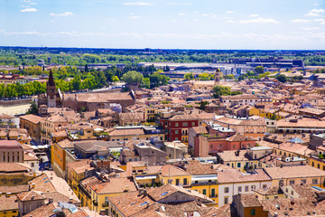 Fototapeta na wymiar Panoramic cityscape of Verona, Veneto, Italy. Orange tiling medieval roofs. Bright sunny summer day.