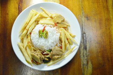 spicy boiled chicken with bamboo shoot in coconut milk curry and rice on plate