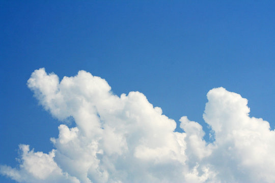 fluffy clouds and blue sky background 