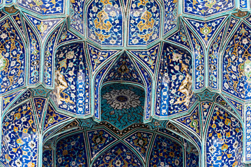From below textured blue colored ceiling in Shah Mosque in Isfahan, Iran.