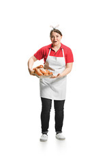Portrait of cute smiling woman with pastries in her hands in the studio, isolated on white background