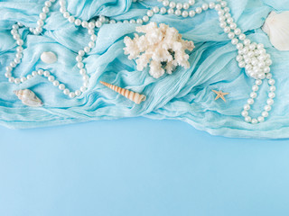 Shells of various kinds on a blue background. Seashells and starfish on a pastel background. Vacation concept