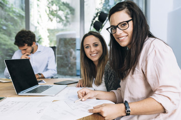 Meeting in a modern office of young architect and engineer while working on a project