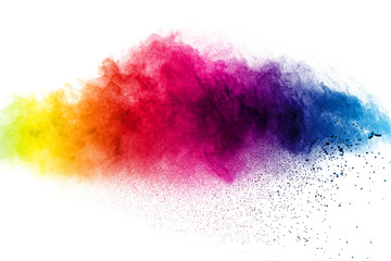 Abstract multi color powder explosion on white background.  Freeze motion of  dust  particles...