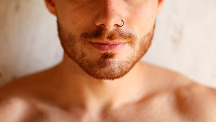 Sensual guy with a piercing on his nose
