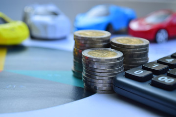 Car insurance. Cars with coins and calculator, finance and loan saving money concept.