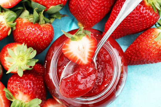 strawberry jam with fresh strawberries. marmalade on spoon and jar