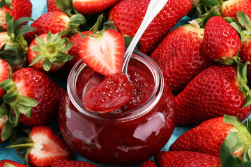 strawberry jam with fresh strawberries. marmalade on spoon and jar