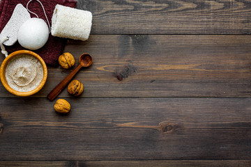 Beauty set with natural walnut scrub for spa on wooden background top view mockup
