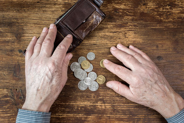 Hands of an old man counting money, rubles. The concept of poverty, austerity in old age.