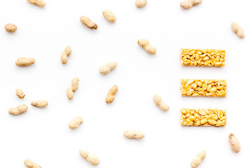 Energy protein snacks with peanuts on white background top view