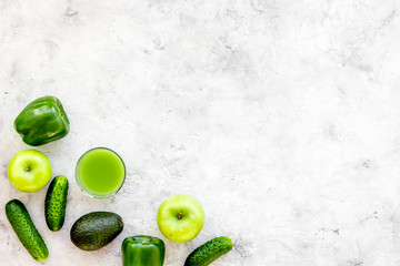 Greeny cocktail ingredients. Fitness smoothie. Cucumber, pepper, apple, avocado on stone background top view space for text