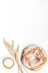 Home bread with classic recipe. Round loaf on white background top view copy space