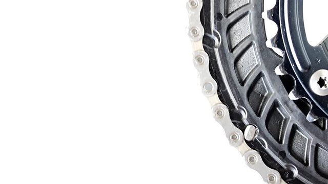 Change direct of way with a drive gear of bicycle rotated on a white background, close-up view.
