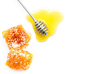 Honey background. Honey dipper and honeycomb on white background top view copy space