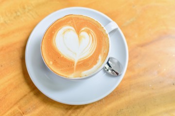Coffee with Latte Art Heart Isolated on Wooden Table
