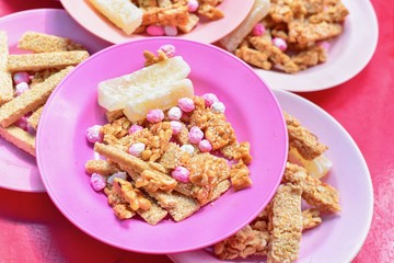 Plate of Traditional Chinese Snacks Consisting of Peanuts and Sesame Candy Bars