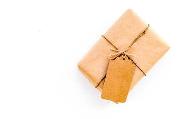 Parcel packaging box wrapped with craft paper with empty label mockup on whitebackground top view copy space