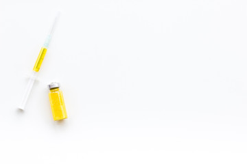 Syringe with colored drug. Injection concept on white background top view copy space